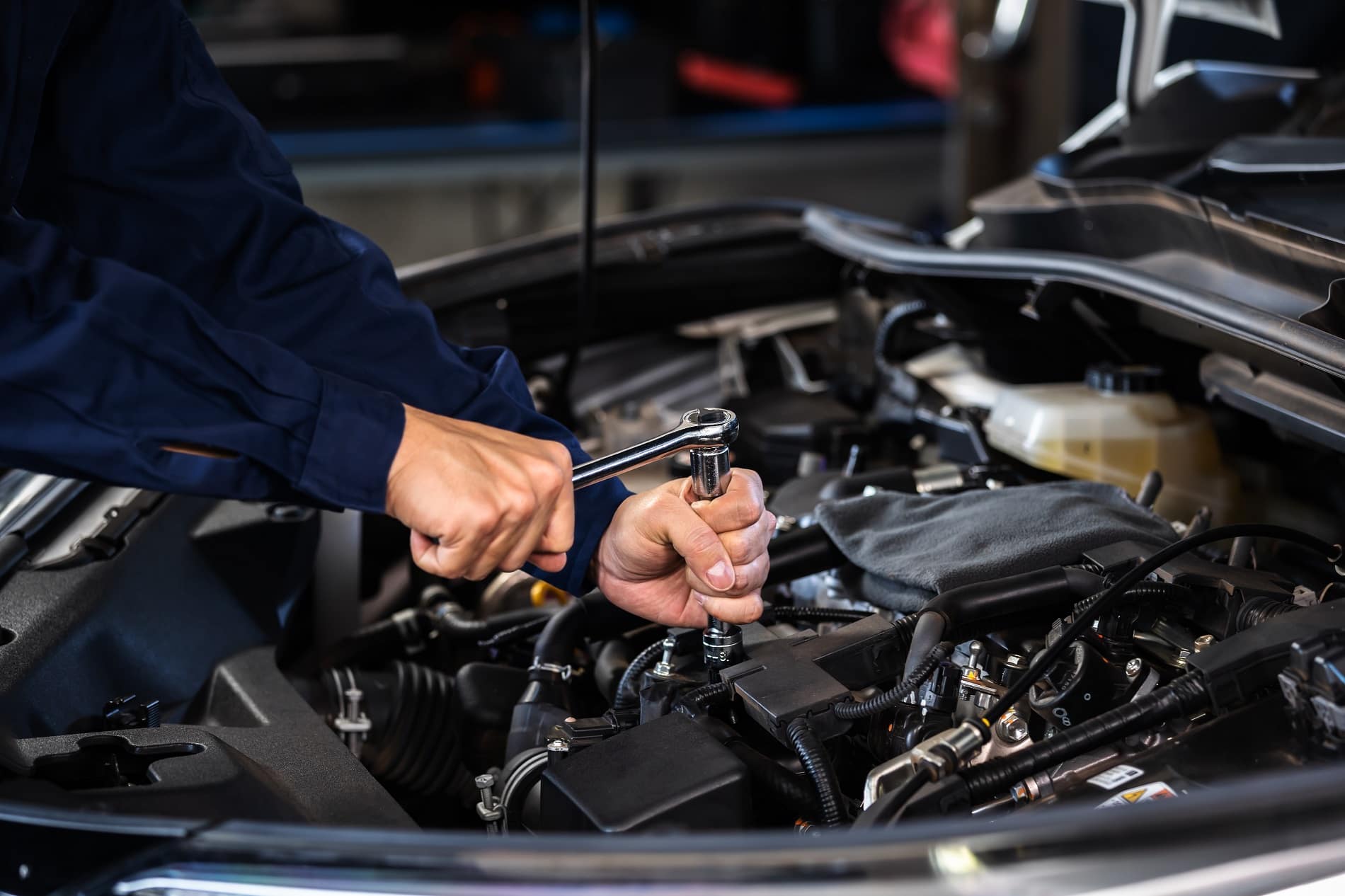 A man maintaining a Honda car